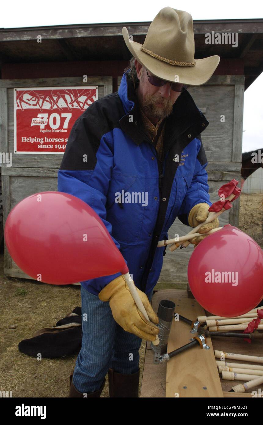 Clayton Case inflates target balloons attached to the end of PVC piping