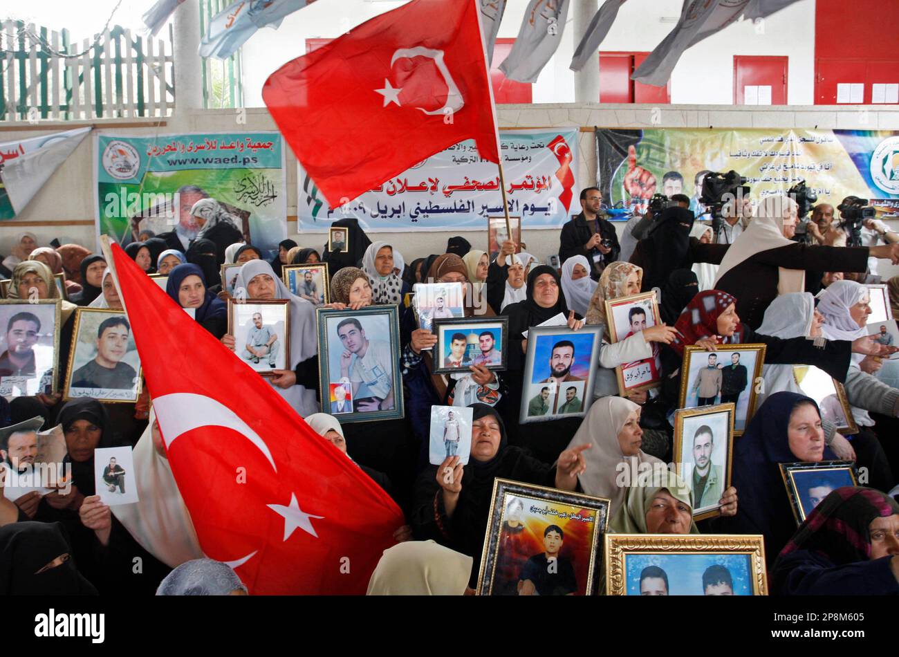 Palestinian women hold Turkish flags, and pictures of Palestinian prisoners  jailed in Israel, during a protest calling for their release in the  International Red Cross building in Gaza City, Monday, April 6,