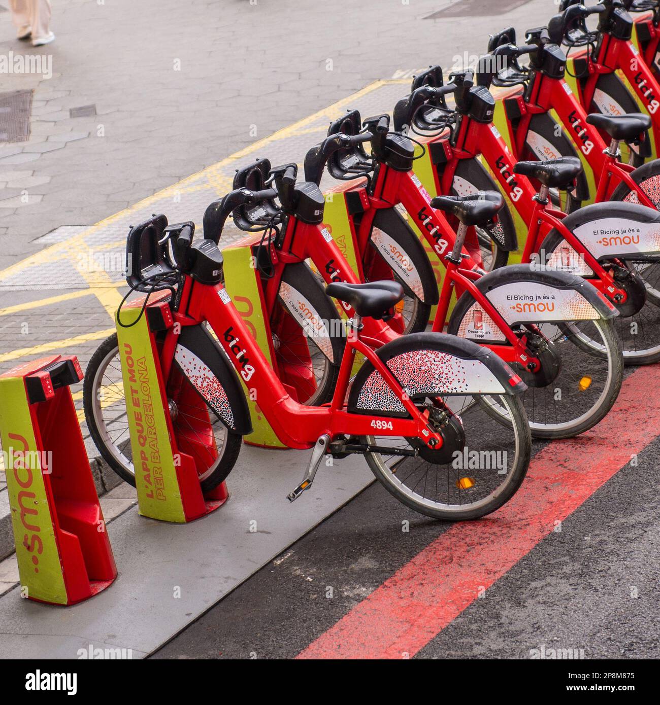 Ebikes lined up for rent  on a busy street . Stock Photo