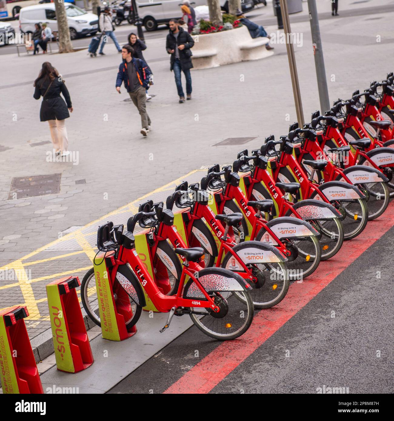 Barcelona,Spain- February 23,2023:Ebikes lined up for rent  on a busy street . Stock Photo