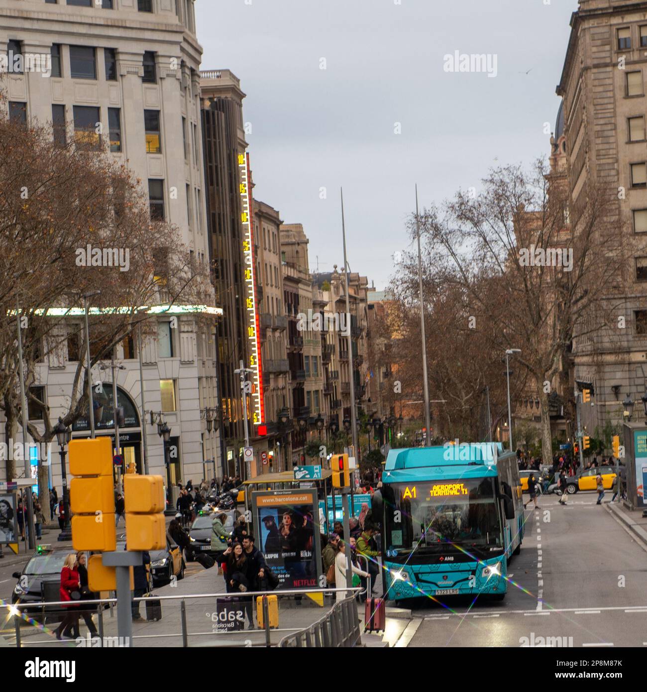 Barcelona,Spain- February 23,2023:A bus going to the airport picksup passengers at a busy stop. Stock Photo