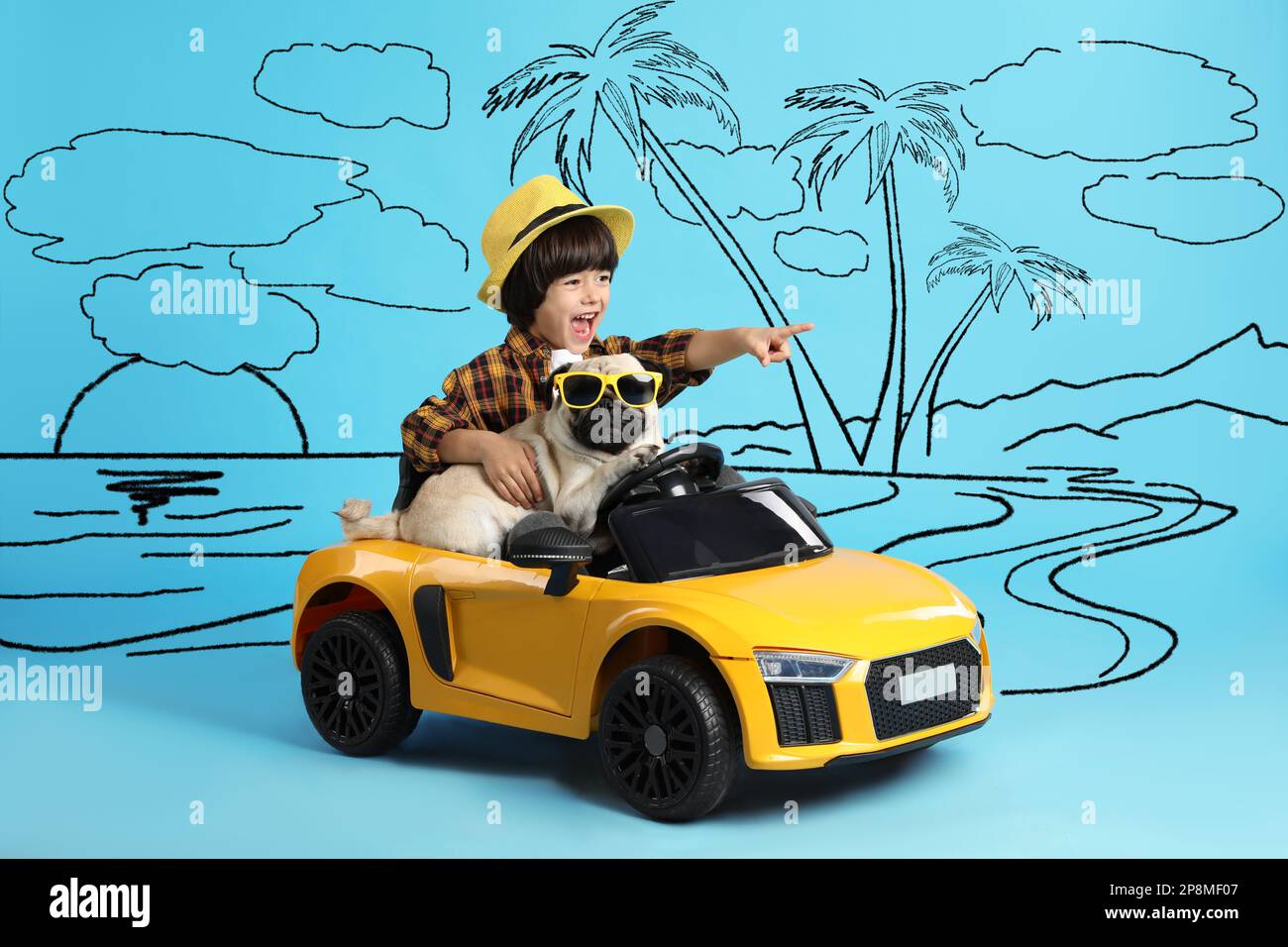 Cute little boy with his dog in toy car and drawing of tropical resort