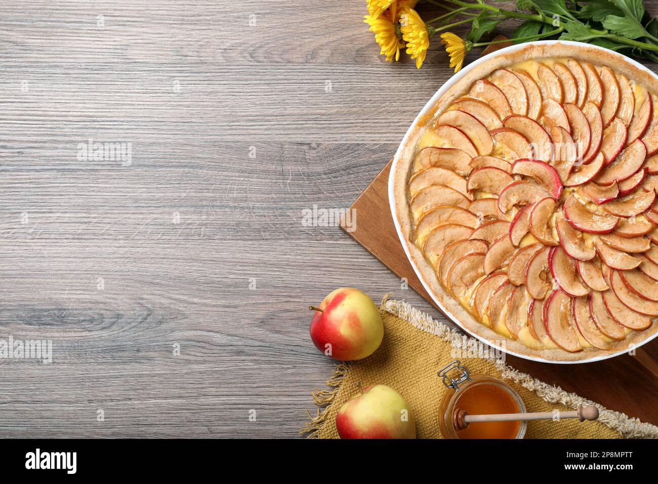 Flat lay composition with tasty apple pie on wooden table, space for text Stock Photo