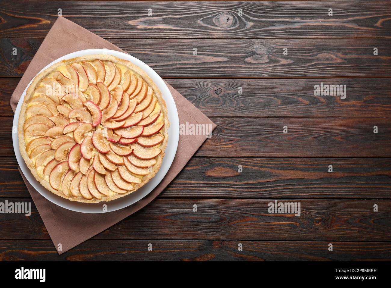 Freshly baked delicious apple pie on wooden table, top view. Space for text Stock Photo