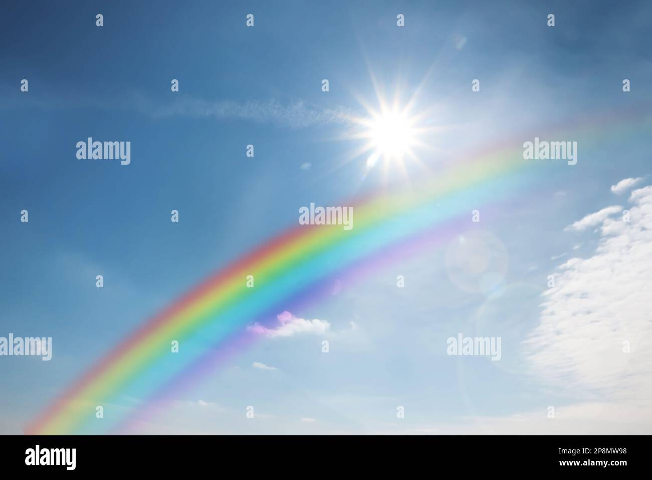 Beautiful rainbow in blue sky with white clouds on sunny day Stock ...