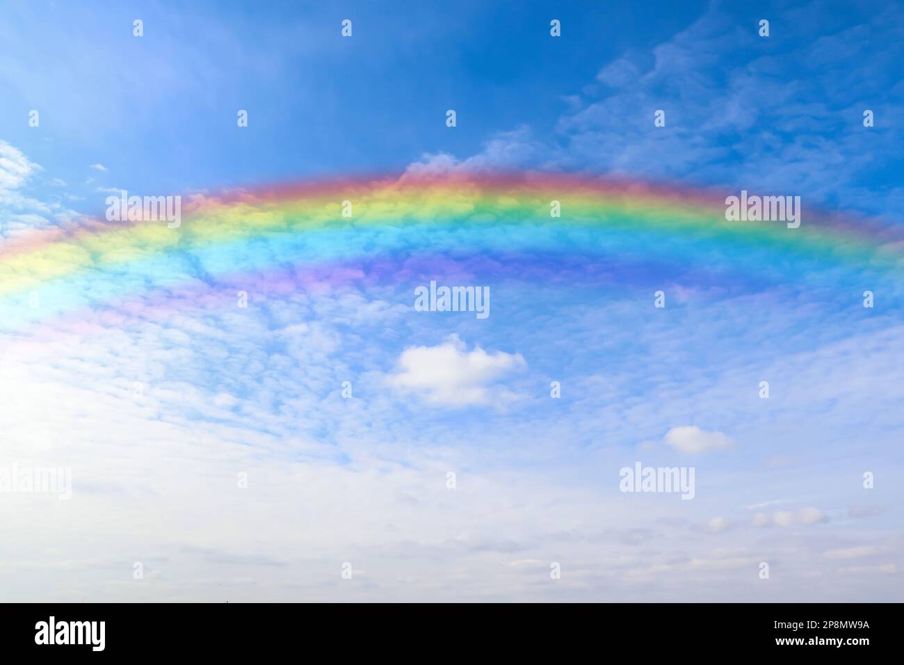 Beautiful rainbow in blue sky with white clouds on sunny day Stock ...