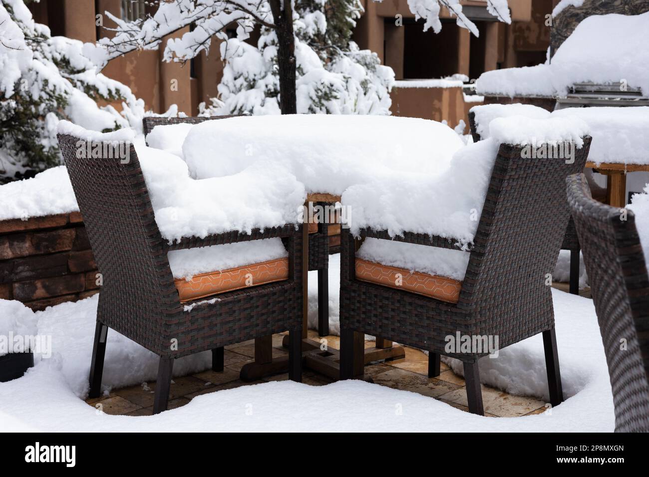 Patio table and charirs buried in deep snow after a rare snow storm in