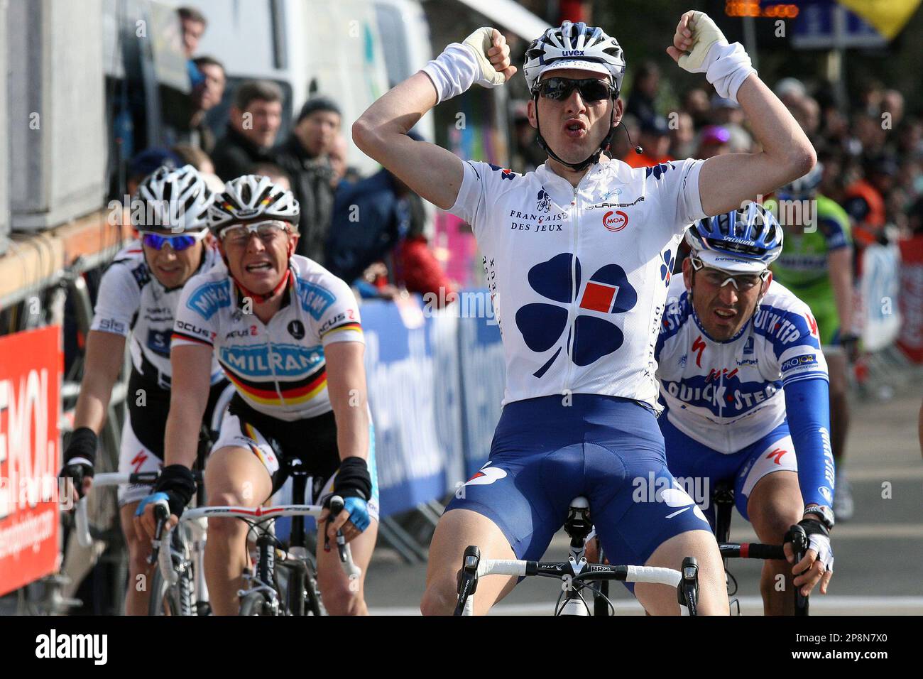 France's Anthony Geslin, center, of the Francaise des Jeux team celebrates as he wins the 49th Brabant Arrow cycling race in Alsemberg, Belgium, Sunday March 29, 2009. Germany's Fabian Wegmann, left, of the Milram team finished second and France's Jerome Pineau, right, of the Quickstep team took the third place. (AP Photo/Geert Vanden Wijngaert) Stock Photo