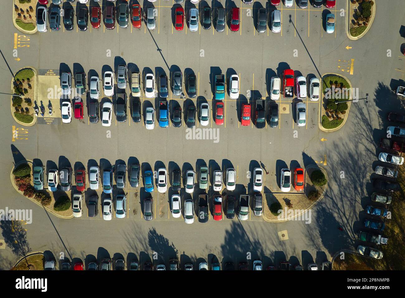 View from above of many parked cars on parking lot with lines and