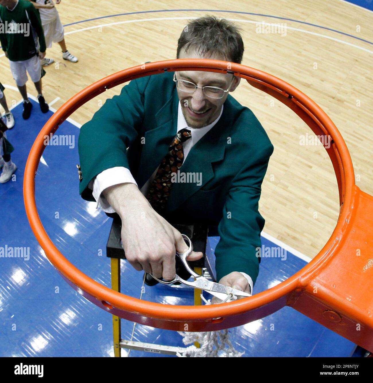 Rocky Mountain coach Bill Dreikosen cuts the net after beating Columbia