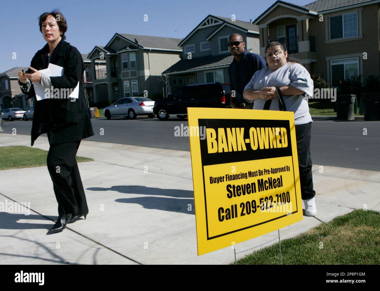 PMZ Real Estate Agent Michelle Zeiter, left, walks into a bank owned