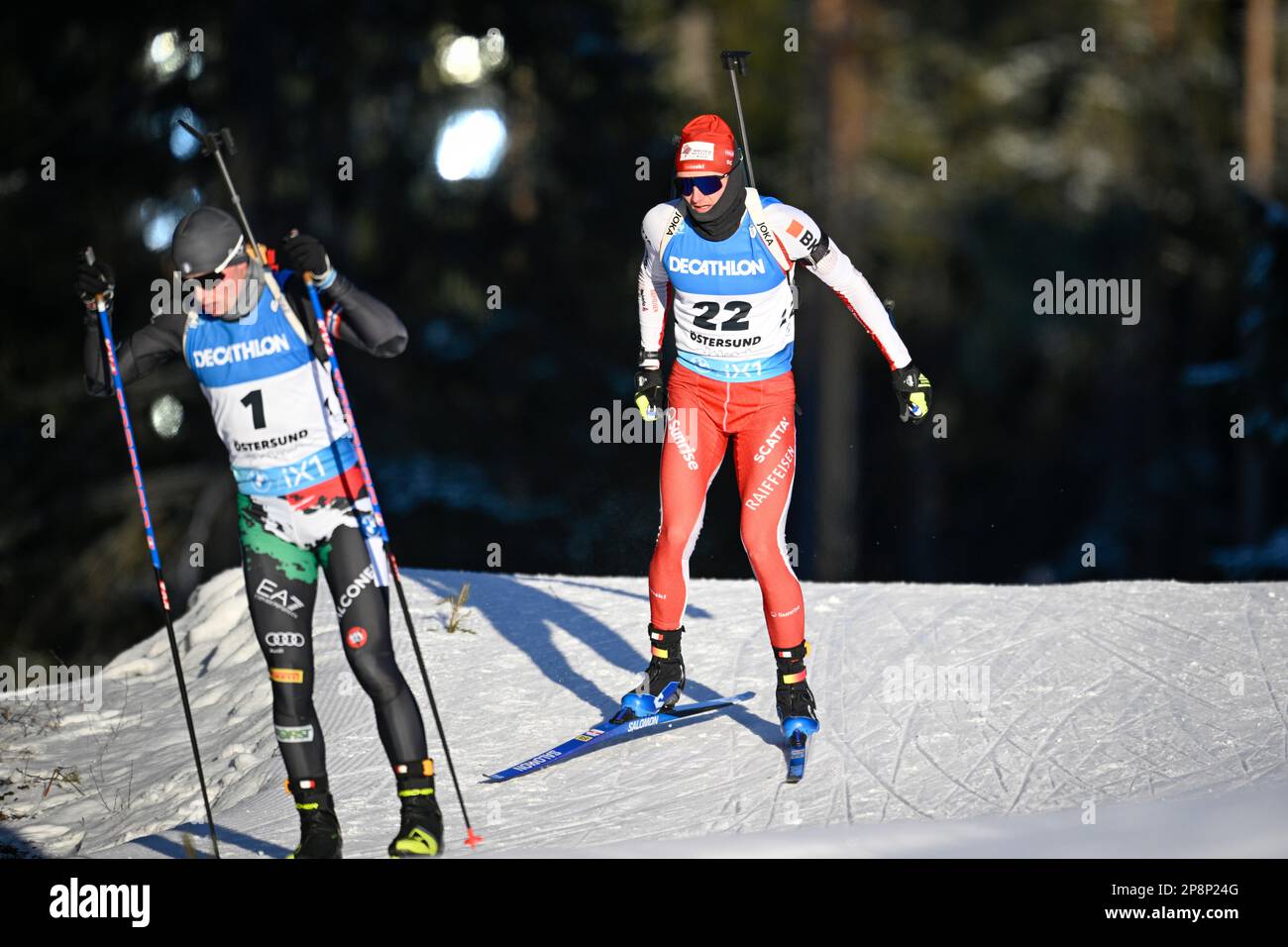 Sebastian Stalder of Switzerland and Elia Zeni of Italy in front in action during the men's 20km individual event of the IBU World Cup Biathlon in Ost Stock Photo