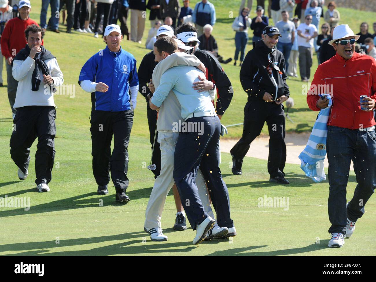 Estanislao Goya, center with back to camera, from Argentina, is hugged by  fellow golfer and countryman Clodomiro Carranza after winning the Madeira  Islands Open golf tournament Sunday, March 22, 2009 at the