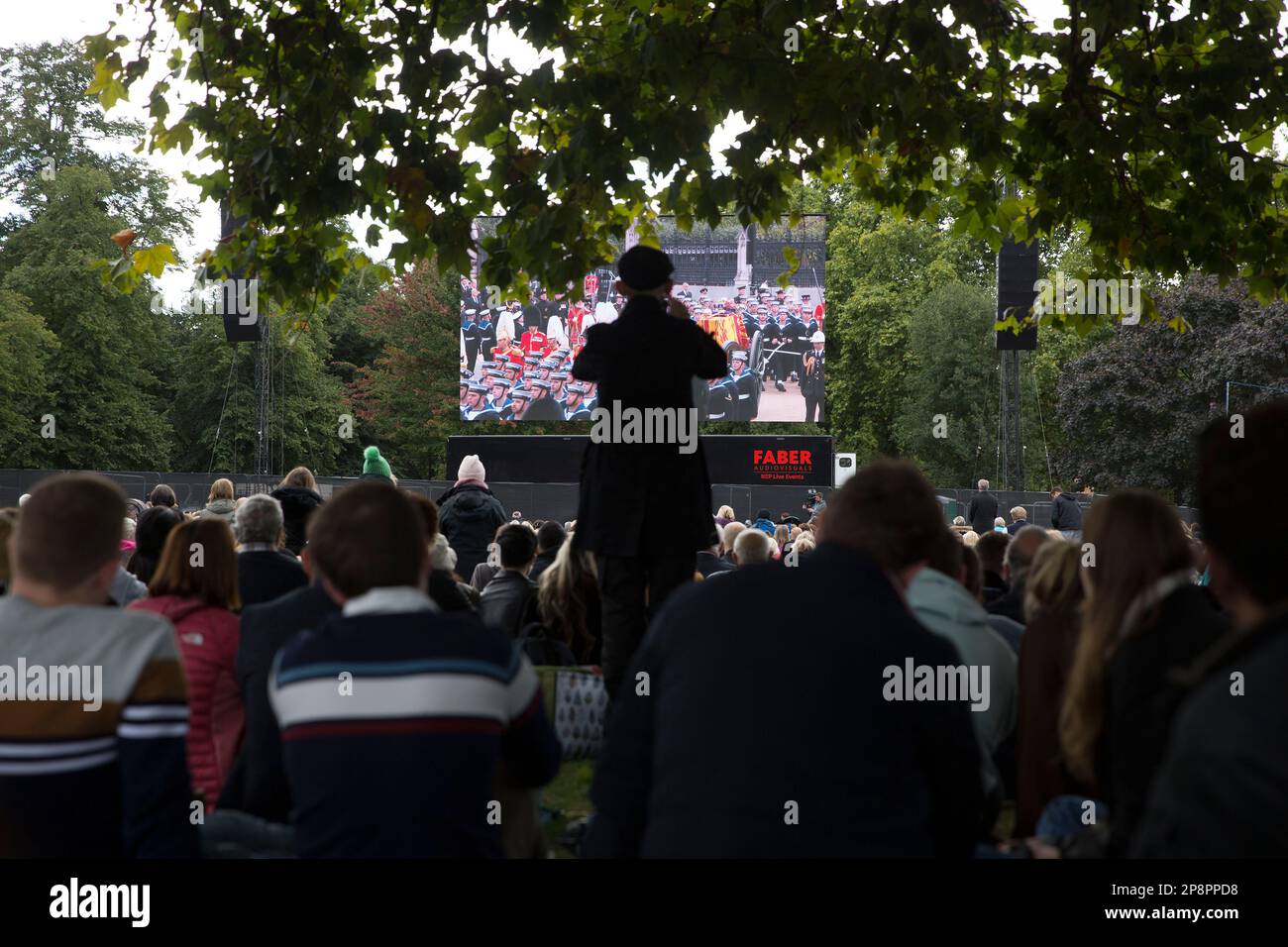People watch the TV coverage of the late Queen Elizabeth II’s funeral