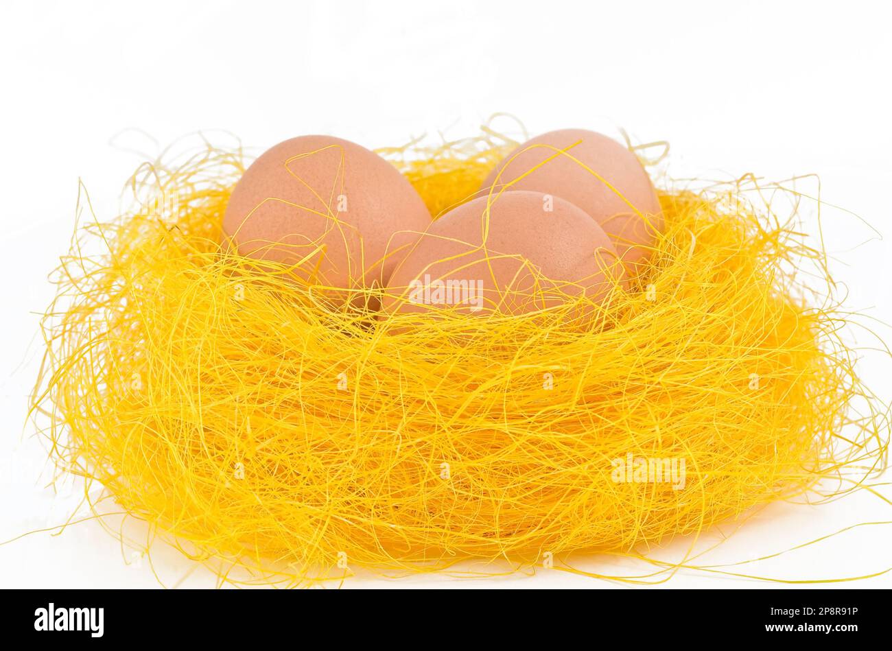 Fresh eggs in nest on white background Stock Photo - Alamy