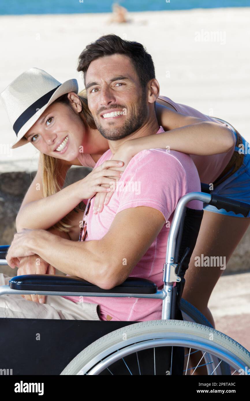 handicapped young couple resting on a beach Stock Photo Alamy