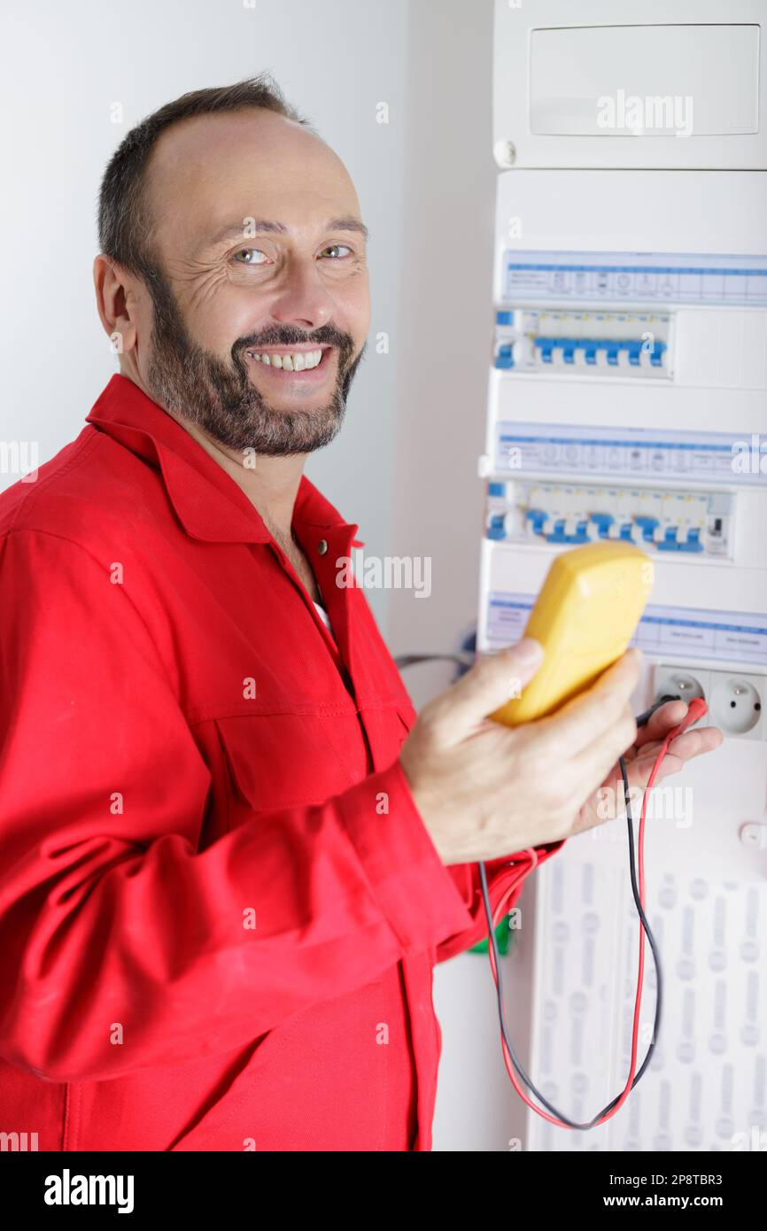 electrician installing energy saving meter Stock Photo