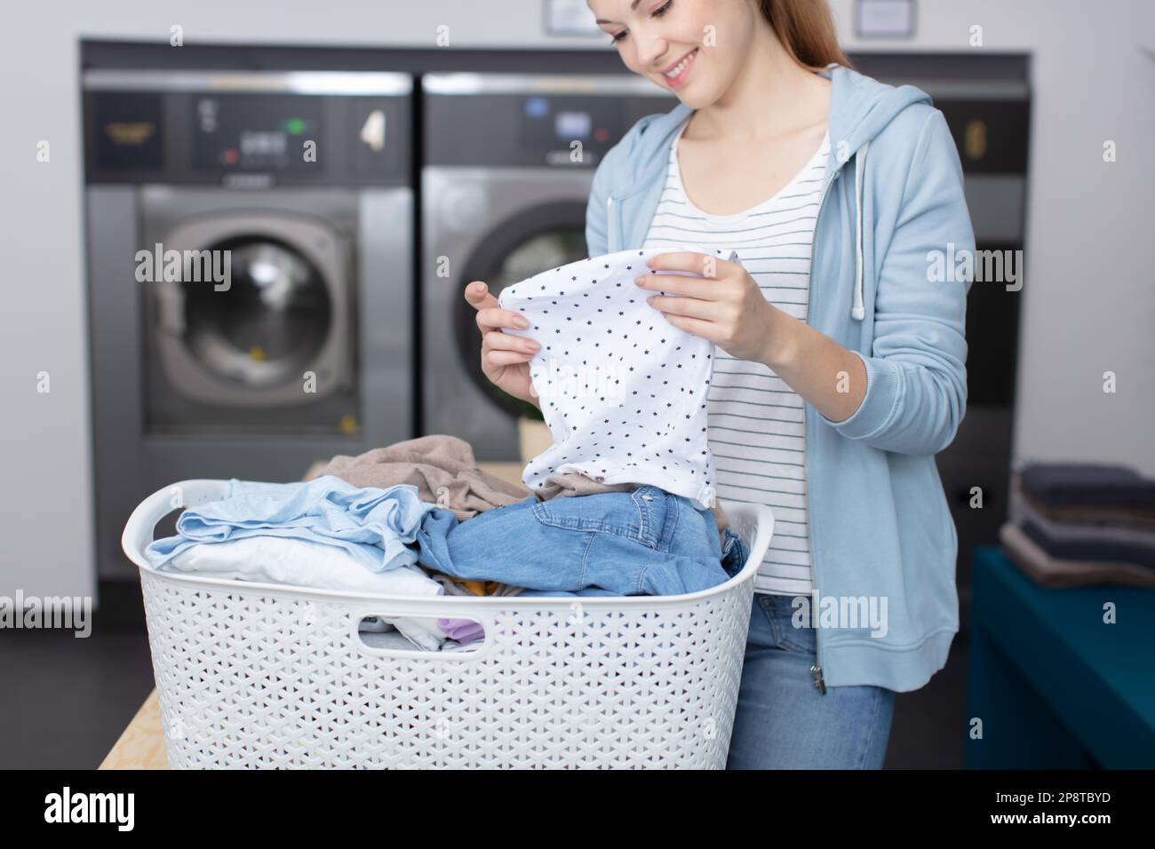 https://c8.alamy.com/comp/2P8TBYD/beautiful-young-woman-is-doing-the-laundry-2P8TBYD.jpg