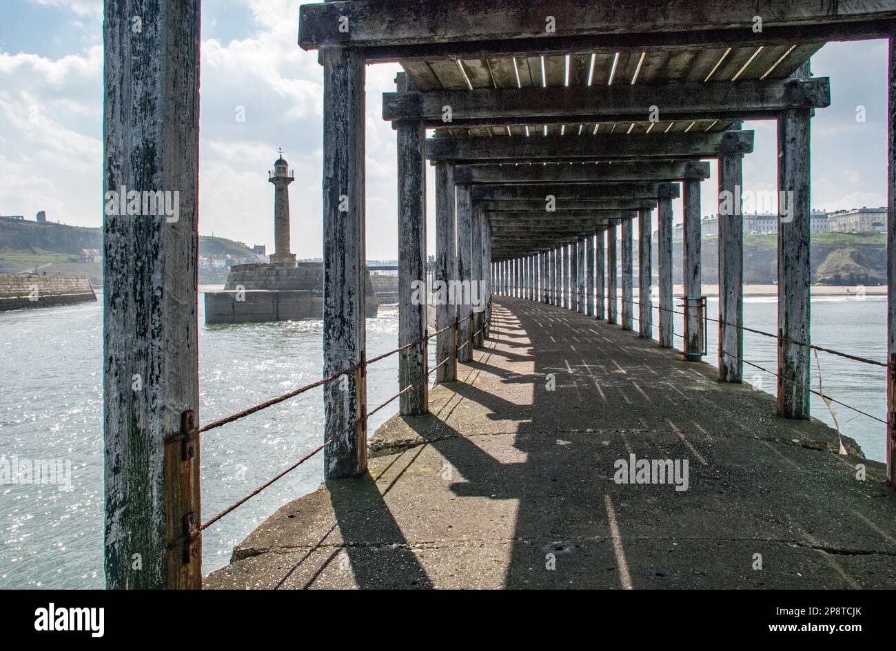 The imposing structure of the wooden pier at Whitby harbour in North ...