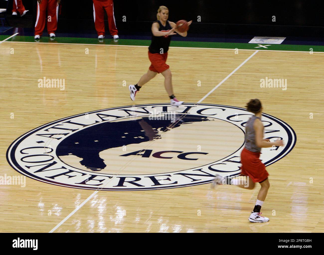 North Carolina State's Inga Muciniece, top, passes to teammate Hanna  Halteman, right, during NCAA college women's basketball practice at the ACC  Conference tournament at the Greensboro Coliseum in Greensboro, N.C.,  Wednesday, March