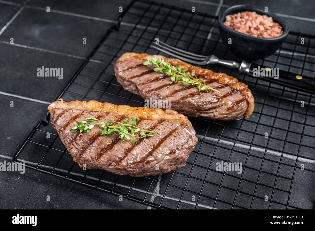 Sirloin Rack Grilled top sirloin or cup rump beef meat steak on a rack. Black ...