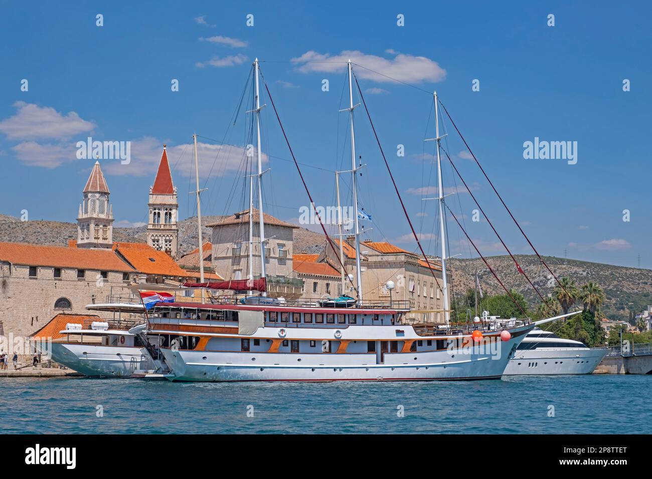 Large sailing ships / yachts moored in harbour of the historic Old Town of Trogir along the Adriatic Sea, Split-Dalmatia County, Croatia Stock Photo