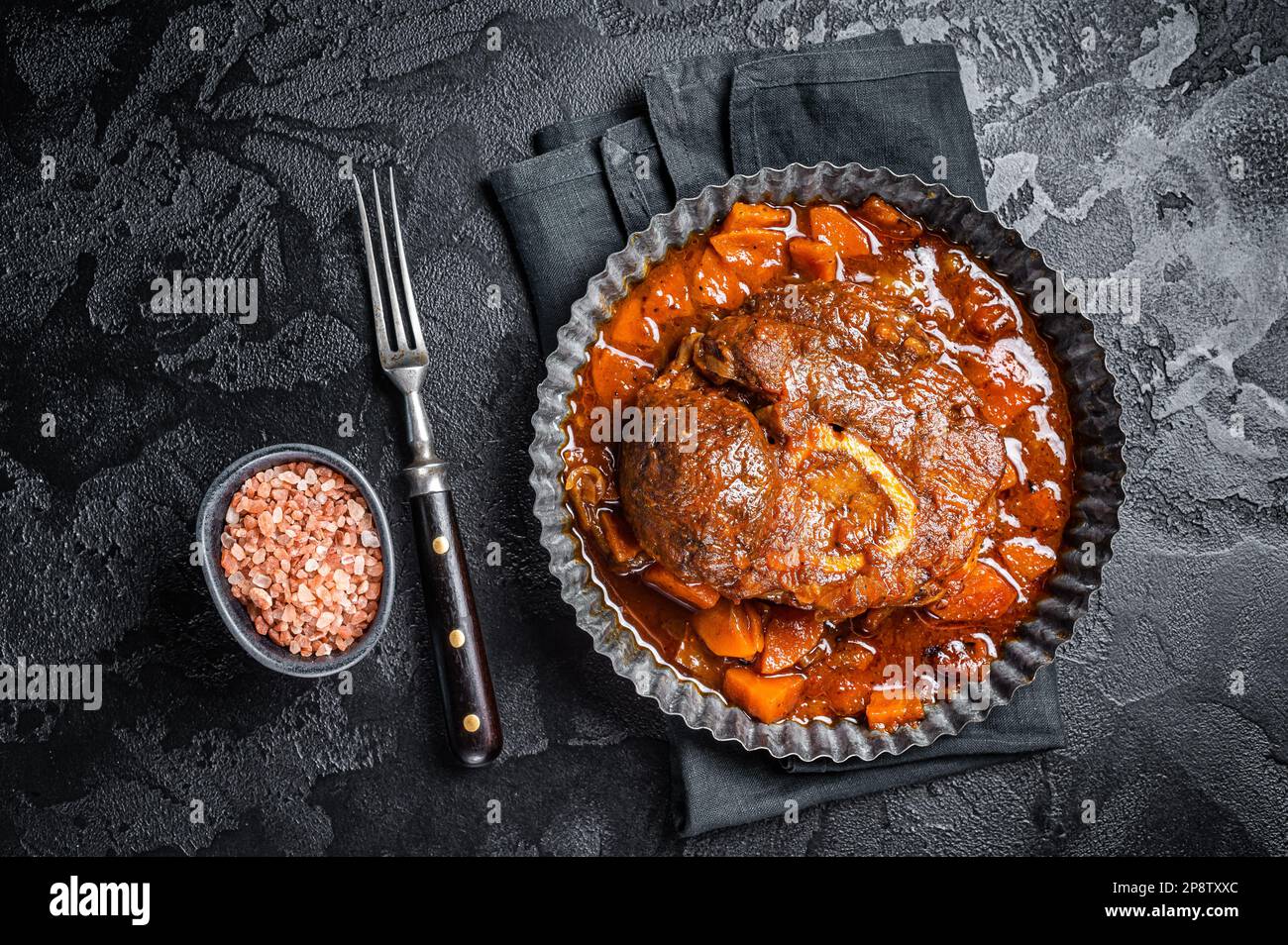 Braised meat on the bone Osso Buco in tomato sauce, veal italian meat