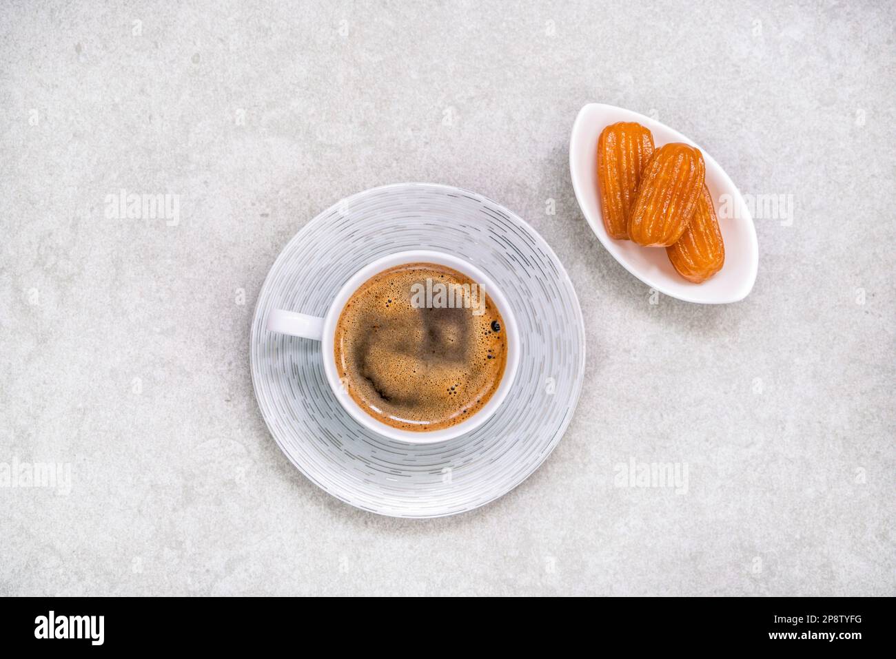 Coffee, Turkish Coffee with traditional dessert with syrup sherbet, one of the traditional dessert known as 'tulumba' in Turkish, Republic of Turkey. Stock Photo