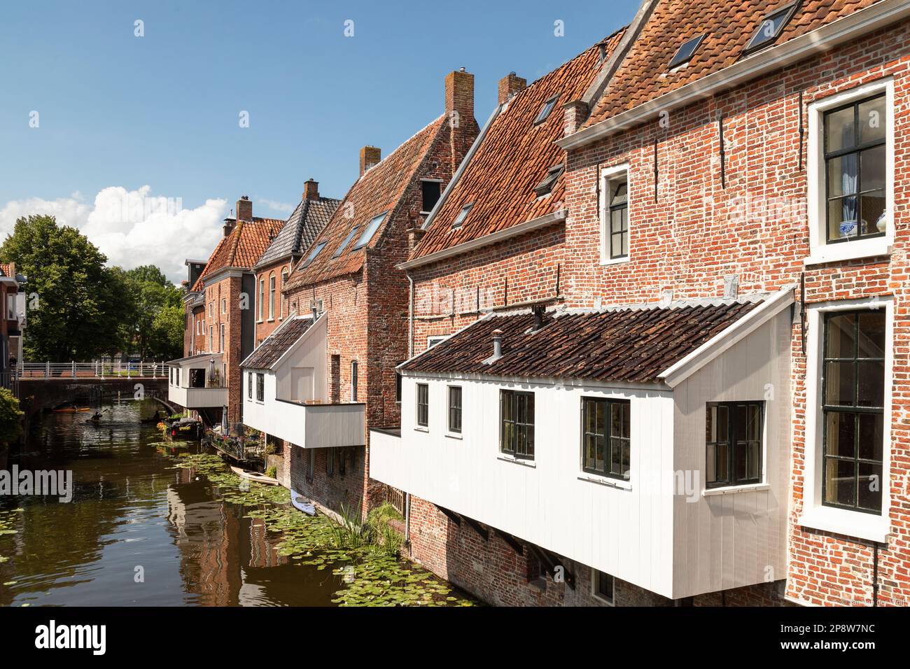 Old houses with attached kitchens above the canal in the picturesque town of Appingedam in the province of Groningen; Netherlands. Stock Photo