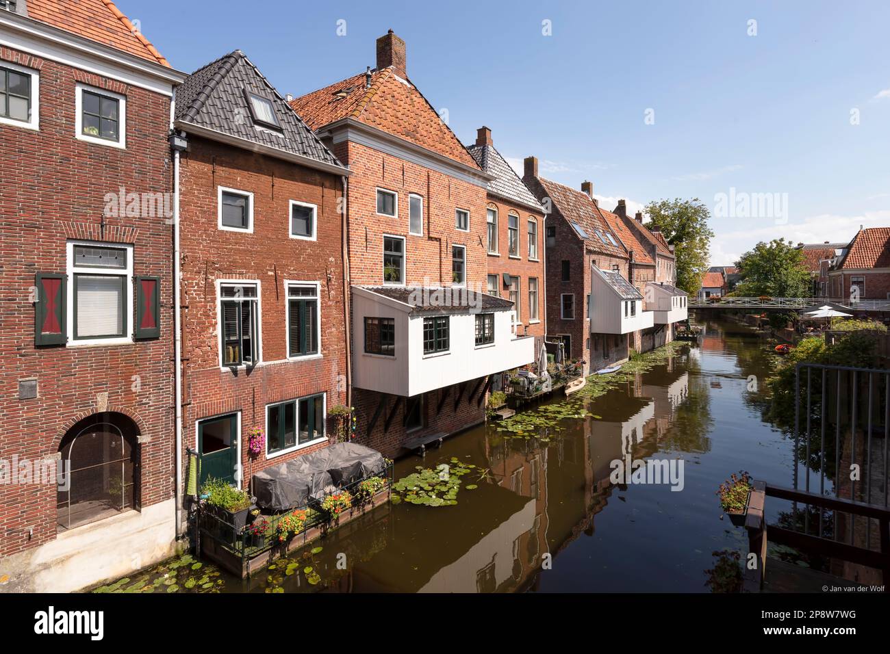 Old houses with attached kitchens above the canal in the picturesque town of Appingedam in the province of Groningen in the Netherlands. Stock Photo