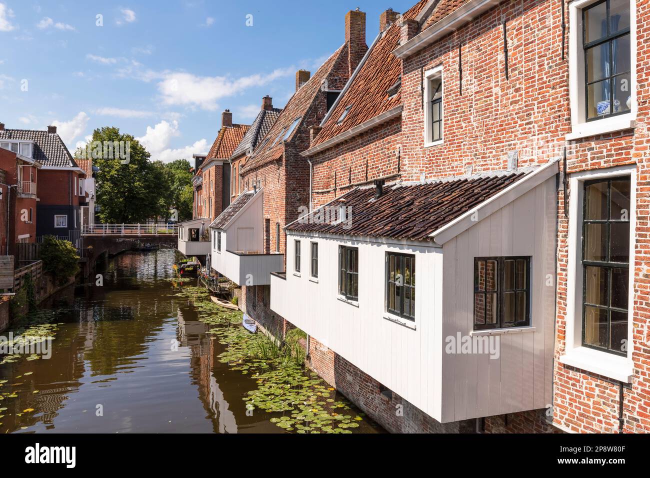 Old houses with attached kitchens above the canal in the picturesque town of Appingedam in the province of Groningen in the Netherlands. Stock Photo