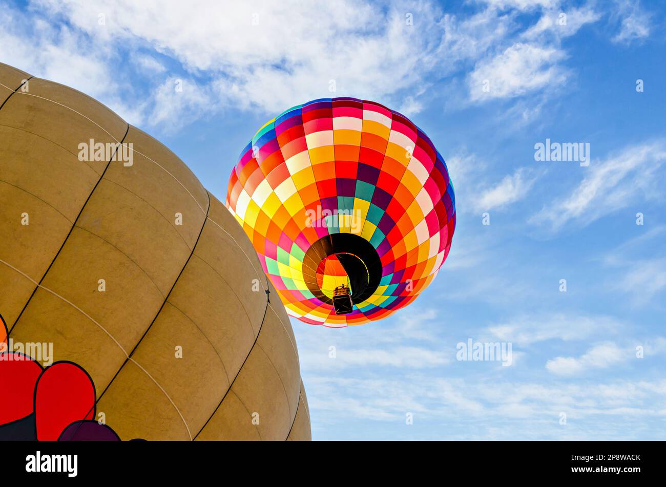 Colorful hot air balloon flying over blue sky with white clouds Stock ...