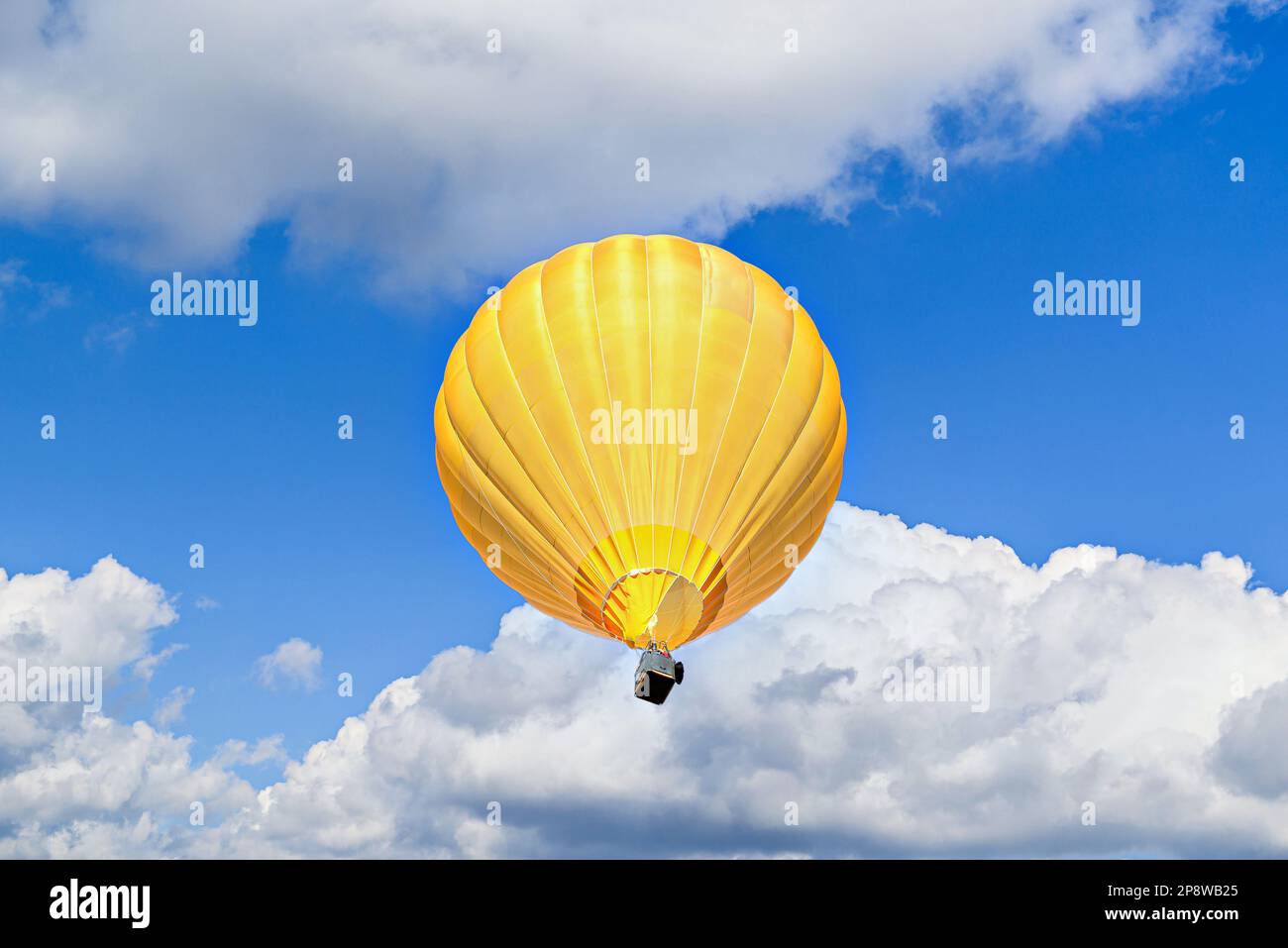 Colorful hot air balloon flying over blue sky with white clouds Stock ...