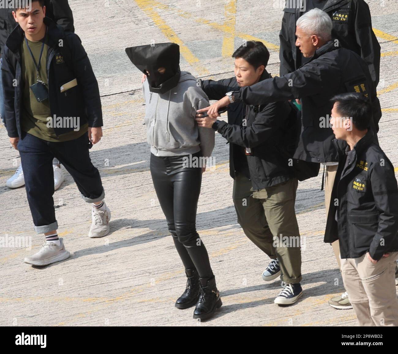 A 29-year-old Hong Kong woman surnamed Pun who is charged over allegedly trying to help Choi's ex-husband Alex Kwong Kong-chi in the brutal murder of model Abby Choi Tin-fung, escorted by police leaves Tin Shui Wai police station. Pun, a Hong Kong influencer, has been arrested in mainland China and become the seventh suspect detained in a murder case that has shocked the world.  07MAR23  SCMP/Yik Yeung-man Stock Photo