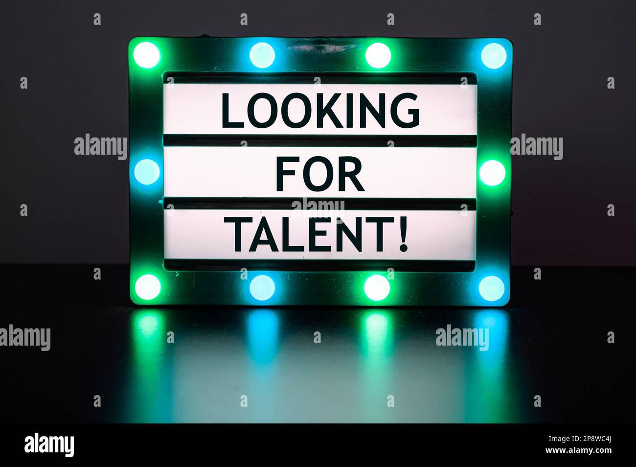 Lightbox with green lights in dark room with words - help wanted! Stock Photo