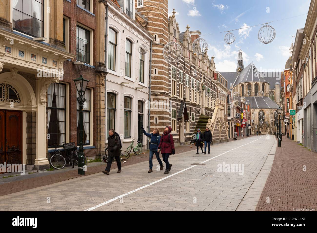 Shopping street in the center of Alkmaar with the Great St. Laurens Church in the background. Stock Photo
