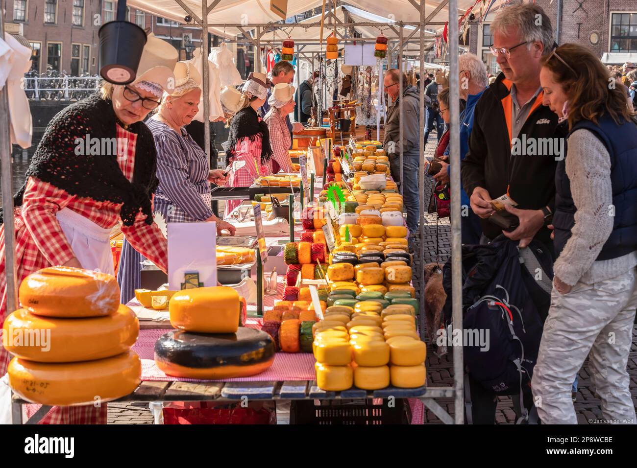Female cheese sellers with traditional clothing on a market stall at