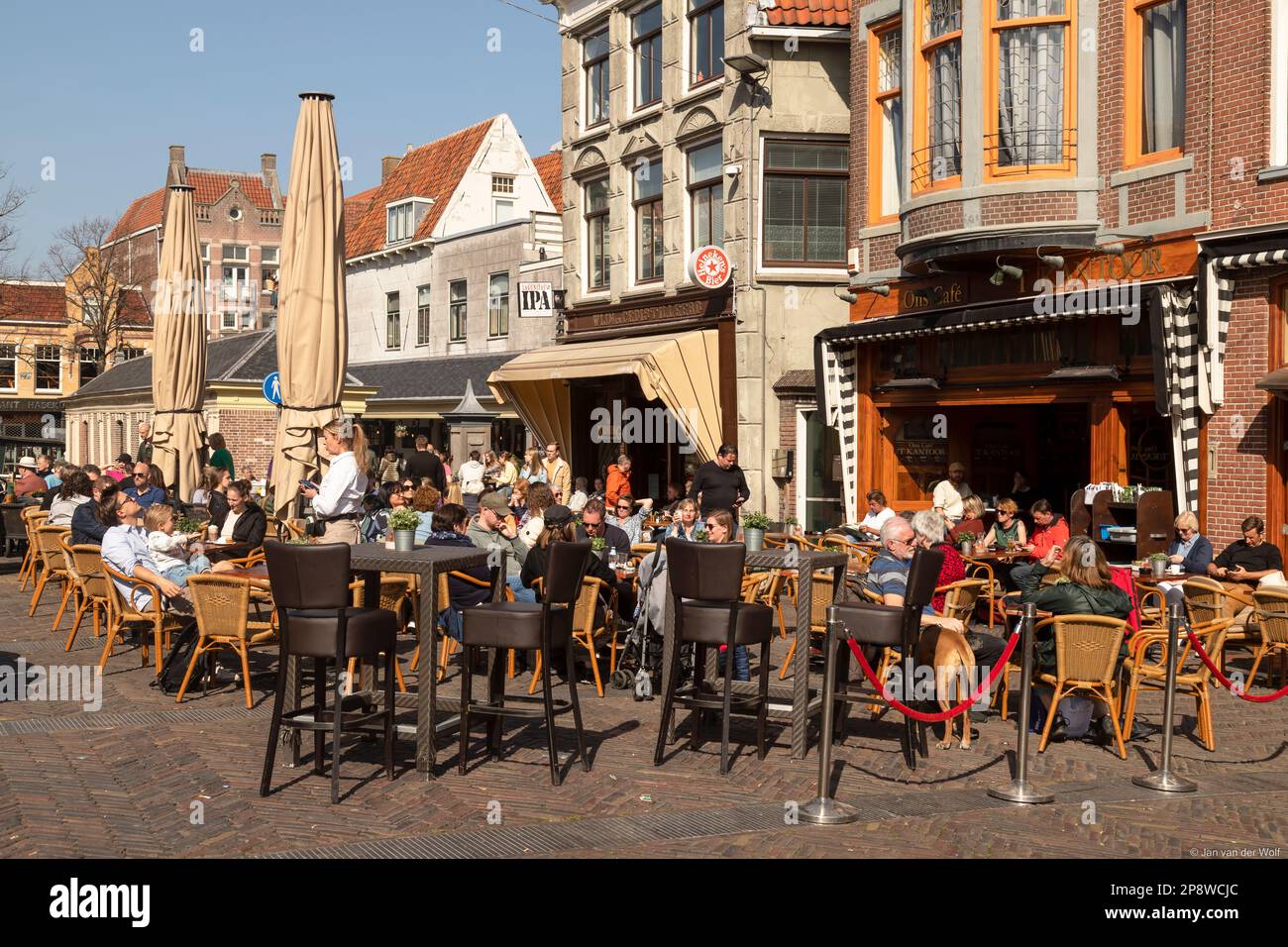 People enjoy a sunny day on the terrace in Alkmaar. Stock Photo
