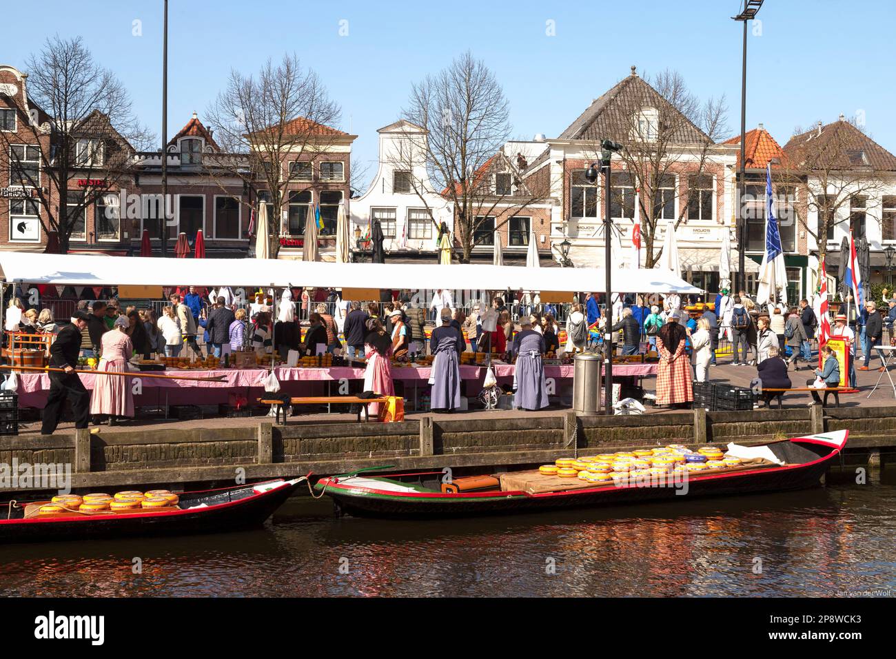 Female sellers of different types of cheese in traditional costume at the cheese market of Alkmaar. Stock Photo