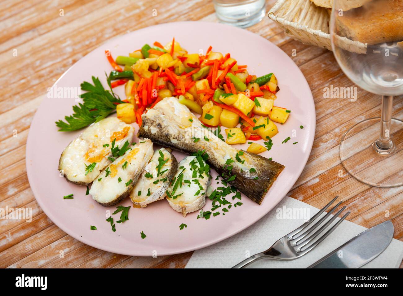 Oven baked hake with vegetable garnish Stock Photo