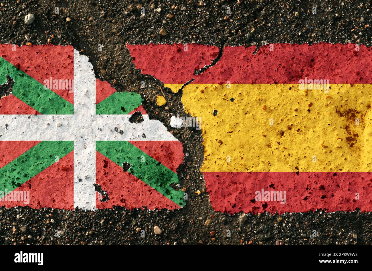 On the pavement there are images of the flags of the Basque Country and Spain, as a confrontation between the two countries. Conceptual image. Stock Photo