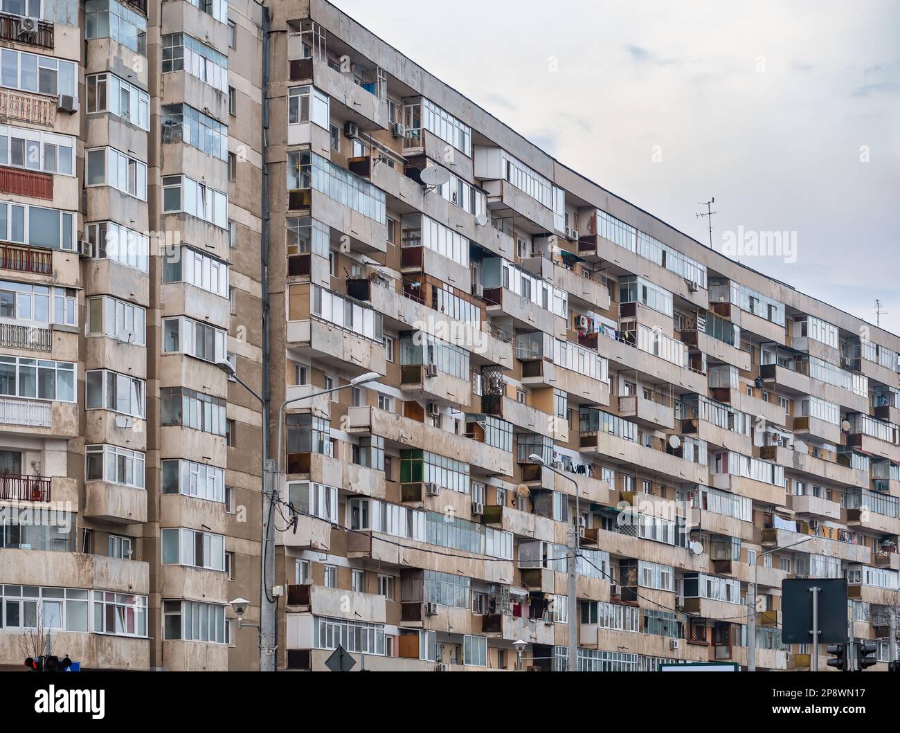 Worn out apartment building from the communist era against blue sky in ...