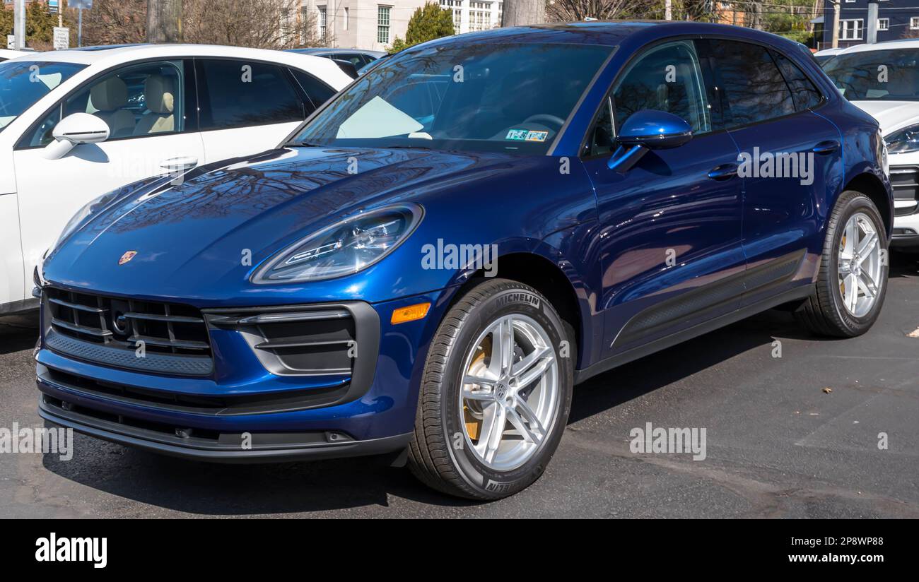 A blue Porsche SUV for sale at a dealership in Sewickley, Pennsylvania