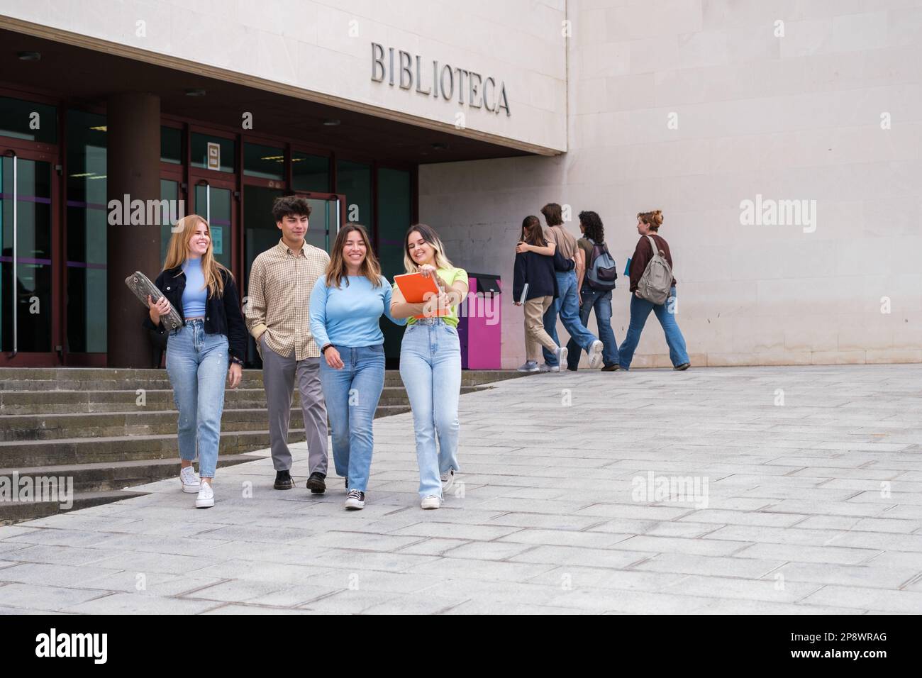 Group of university students leaving the library to prepare for final exams. Concept: Study, University career, higher studies Stock Photo