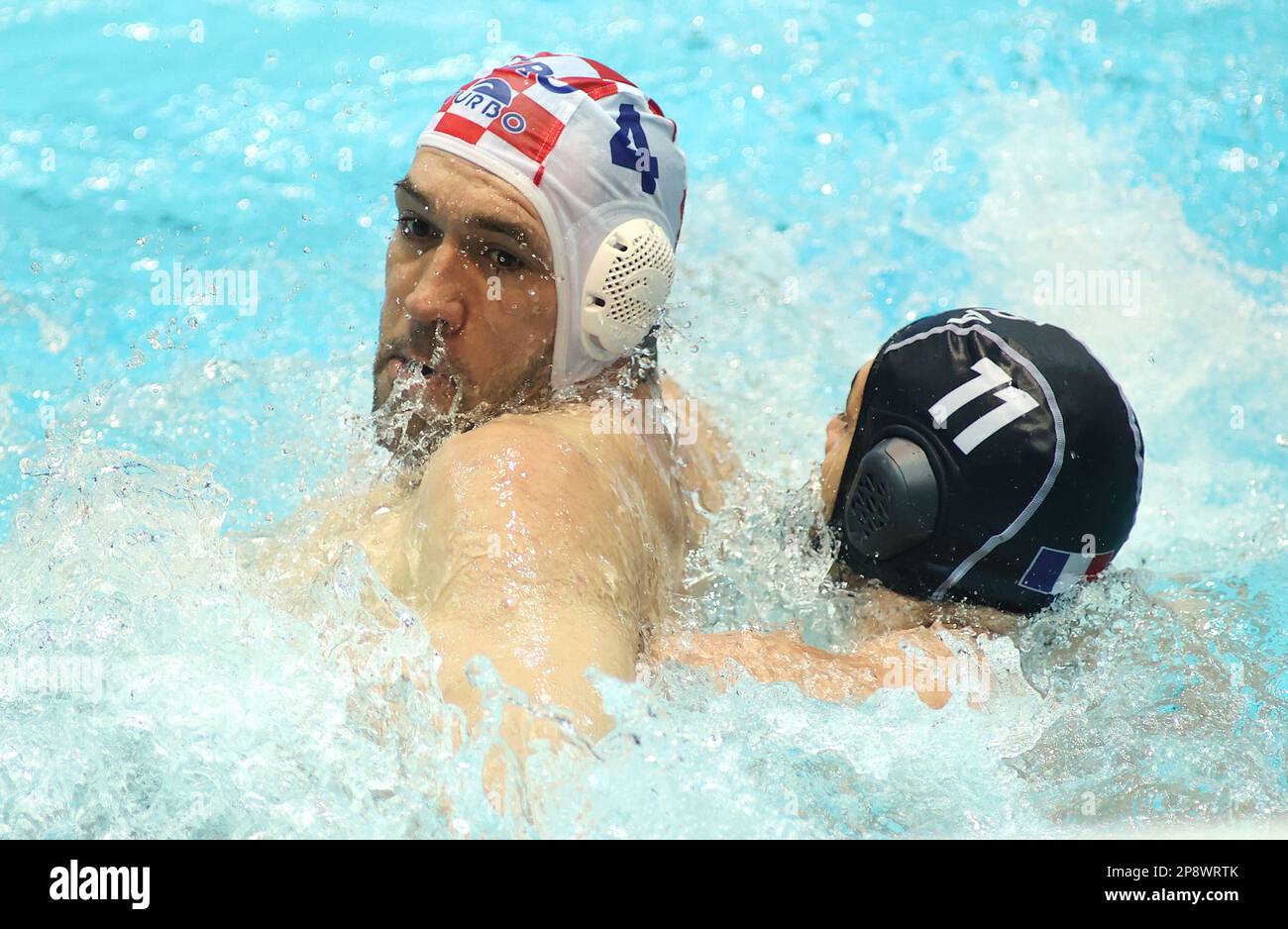 ZAGREB, CROATIA - [DATE]: Pierre-Frederic Vanperstraete of France and Ivan Krapic of Croatia fightning for the ball during the Men's Water Polo World Cup match between France and Croatia on March 9, 2023 in Zagreb, Croatia. Photo: Marko Prpic/PIXSELL Stock Photo