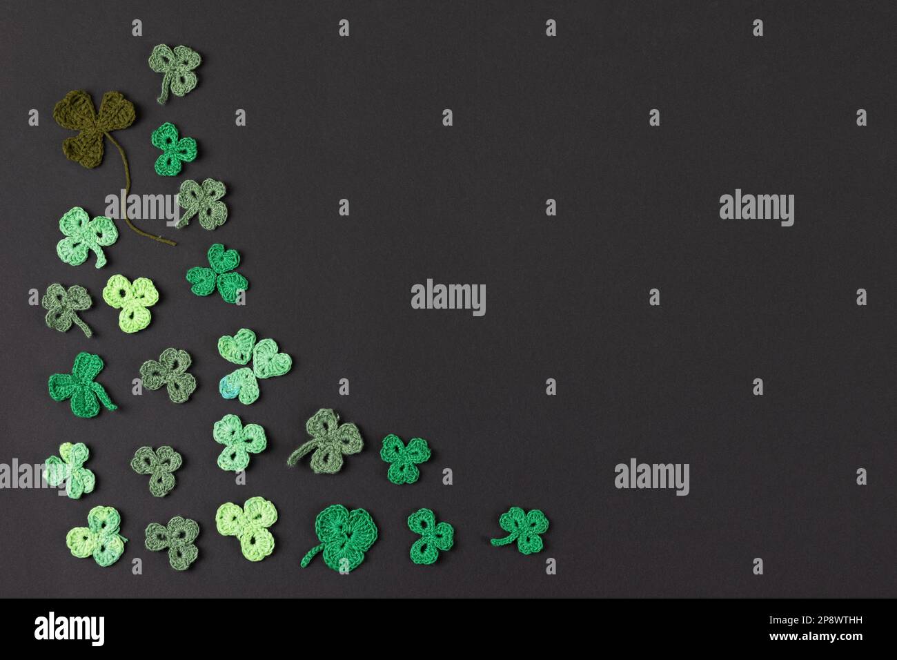 St Patrick's Day side border made of knitted green shamrocks on a black  background. Holiday sign and knitted clover leaf. Copy space, flat lay,  place Stock Photo - Alamy, image size:1300x956