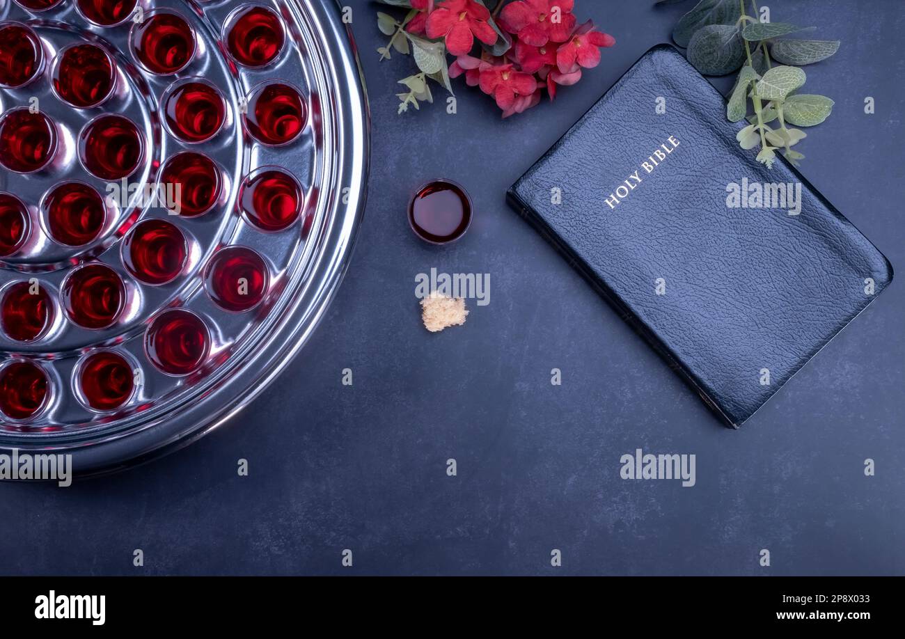 Taking communion concept - the wine and the bread symbols of Jesus Christ blood and body with Holy Bible. Easter Passover and Lord Supper concept. Stock Photo