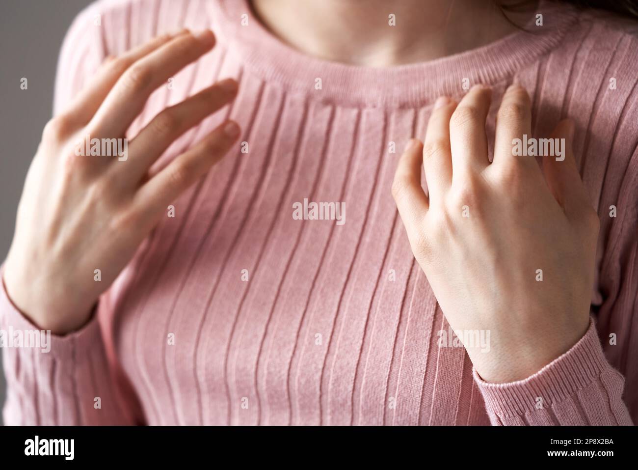 Teenage girl tapping on the collarbone point - practicing EFT or emotional freedom technique Stock Photo