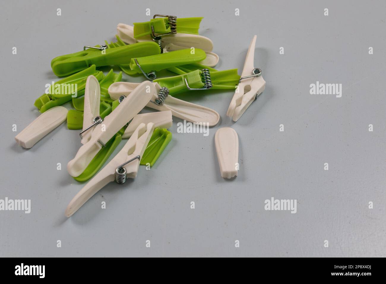 Broken cheap plastic clothes pegs that keep breaking with little use Stock Photo