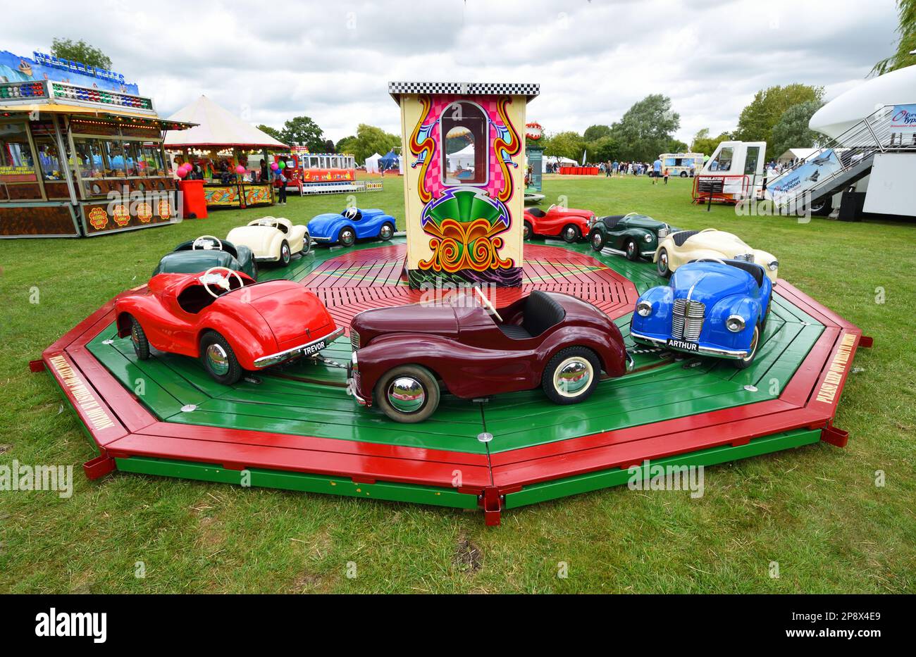 Children's roundabout with classic Austin pedal cars Stock Photo Alamy